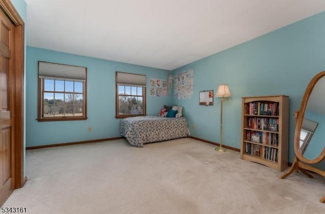 bedroom featuring carpet and baseboards