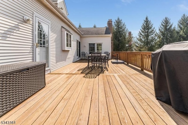 wooden terrace featuring outdoor dining space