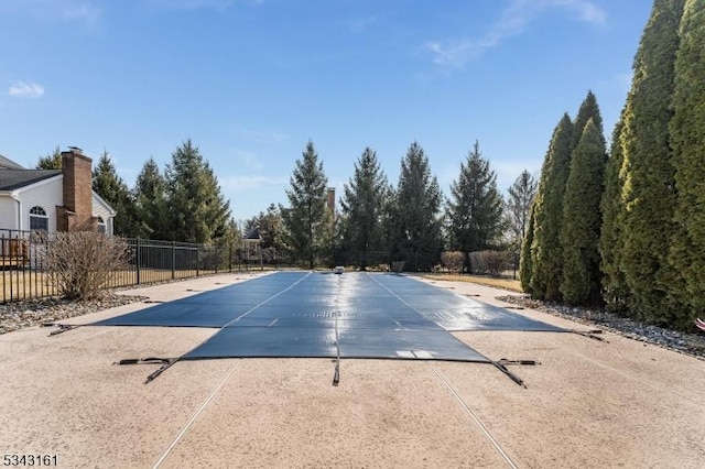 view of swimming pool with a patio area, a fenced in pool, and fence