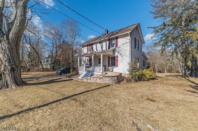 view of front of property with a porch and a front yard