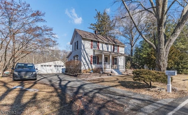 colonial home featuring covered porch and an outdoor structure