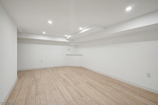 empty room with recessed lighting, light wood-type flooring, and baseboards