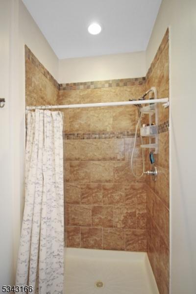 full bathroom featuring a stall shower