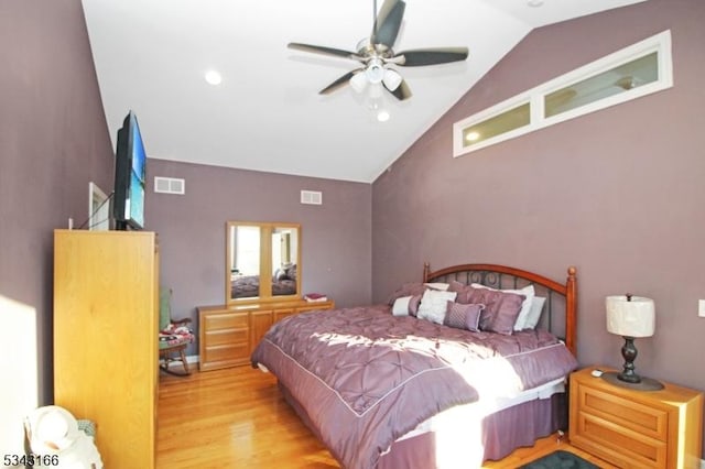 bedroom with visible vents, wood finished floors, a ceiling fan, and vaulted ceiling