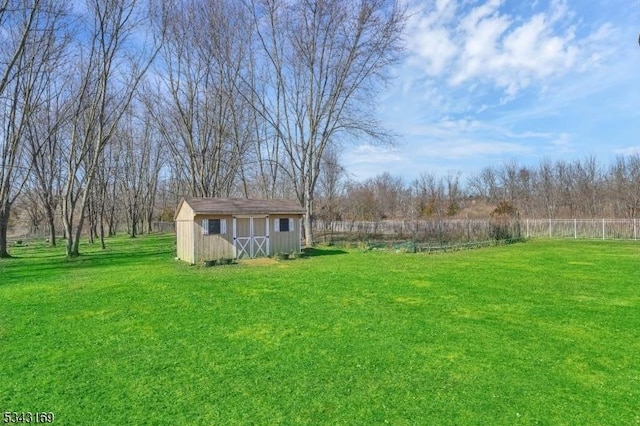 view of yard with a storage unit, an outdoor structure, and fence