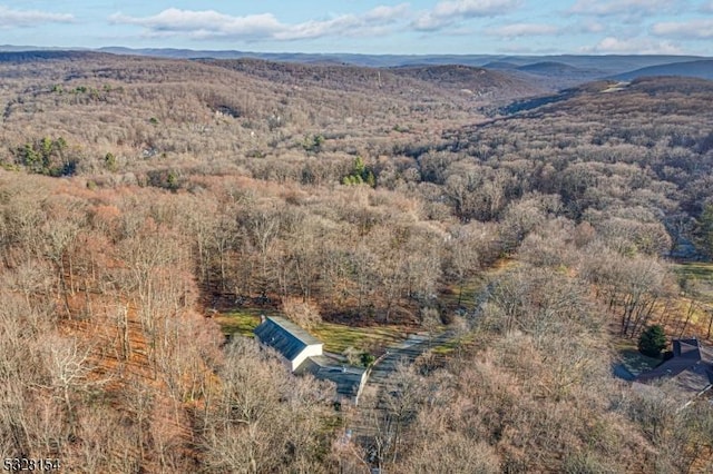 drone / aerial view with a mountain view and a wooded view