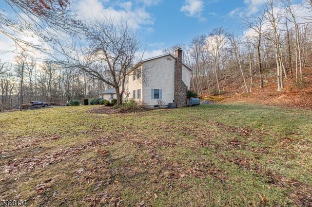 exterior space featuring a lawn and a chimney