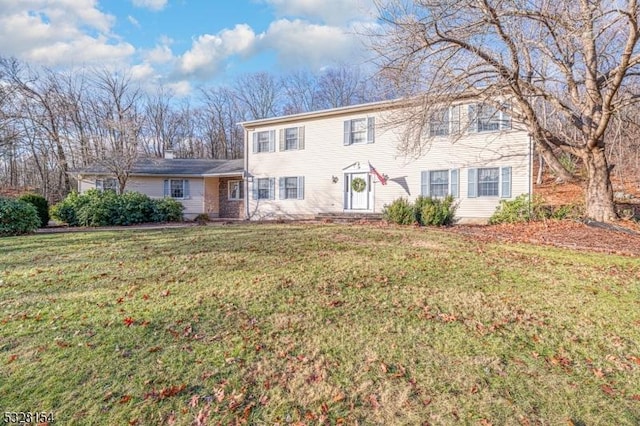 colonial home featuring a front lawn