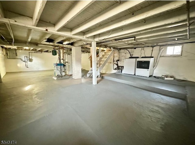 basement with stairway, independent washer and dryer, and a sink