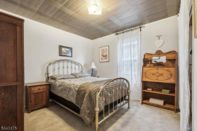 bedroom featuring wooden ceiling and light carpet