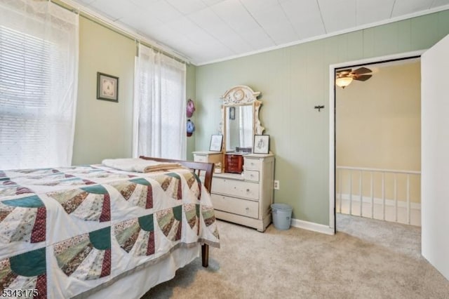 bedroom with multiple windows, carpet, and baseboards