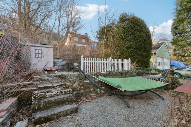 view of yard featuring an outdoor structure and fence