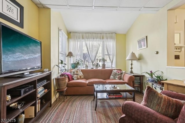 living area with a paneled ceiling