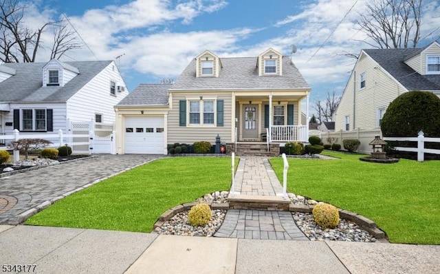 new england style home featuring a front lawn, fence, a porch, decorative driveway, and an attached garage