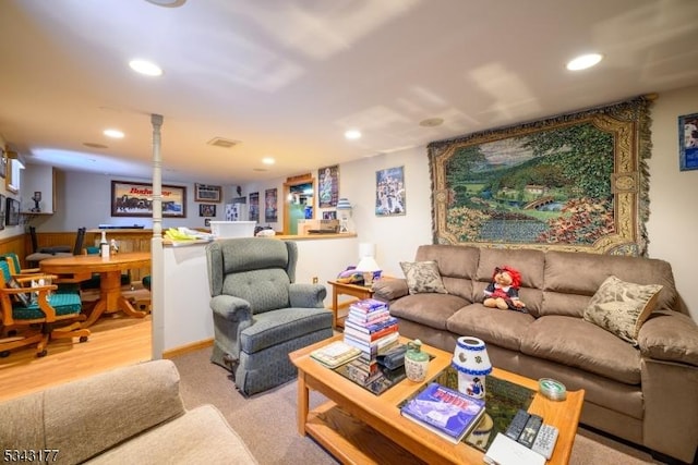 living area with visible vents, recessed lighting, and carpet floors