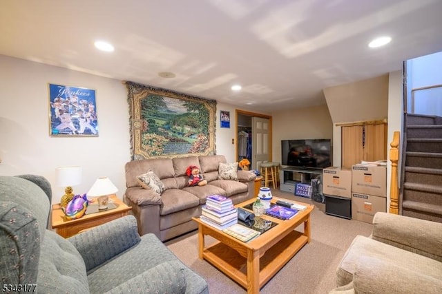 living room with recessed lighting, light colored carpet, and stairs