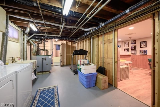 unfinished basement with a sink and separate washer and dryer