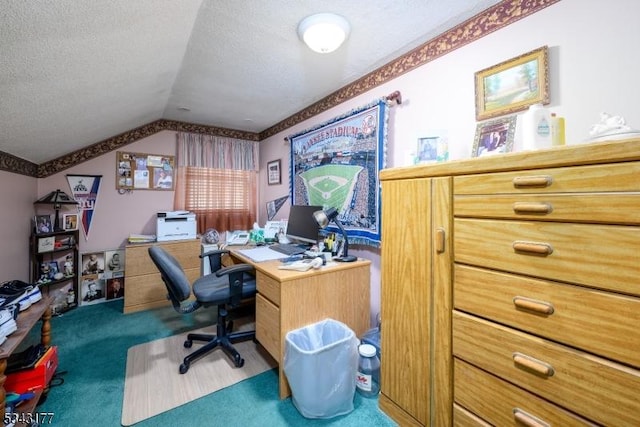 home office featuring lofted ceiling, carpet flooring, and a textured ceiling