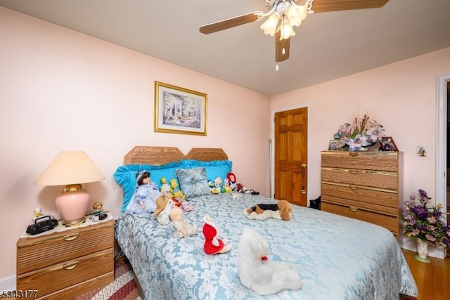 bedroom with ceiling fan and wood finished floors