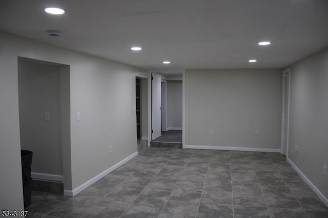 unfurnished room featuring recessed lighting and baseboards