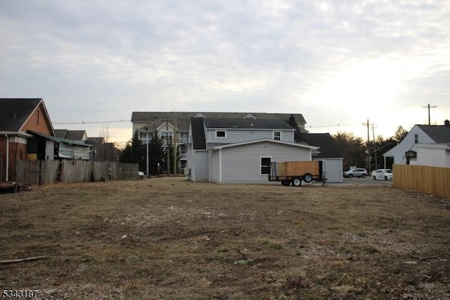 rear view of house featuring fence