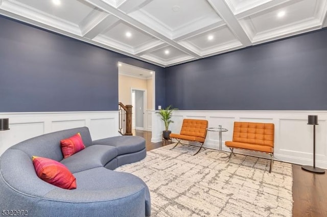 sitting room featuring ornamental molding, beam ceiling, recessed lighting, wood finished floors, and coffered ceiling