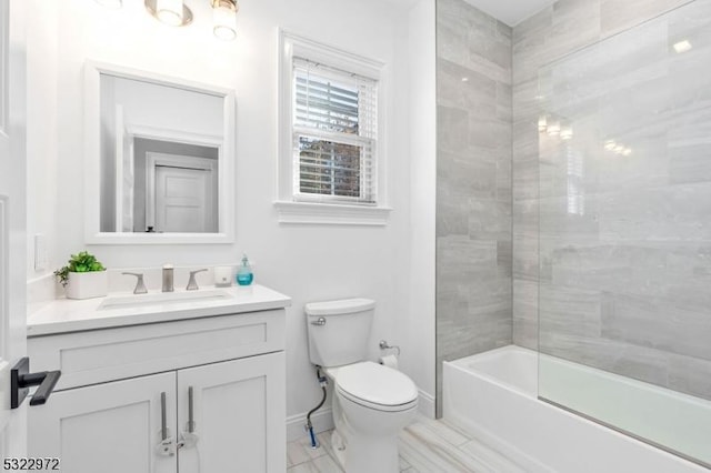 bathroom featuring vanity, toilet, washtub / shower combination, and baseboards