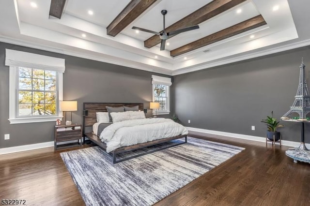 bedroom featuring a tray ceiling, wood finished floors, baseboards, and beam ceiling