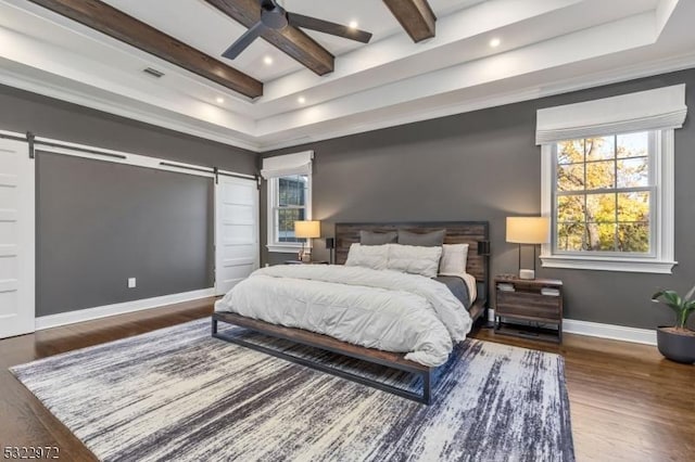 bedroom featuring wood finished floors, baseboards, recessed lighting, a barn door, and beamed ceiling