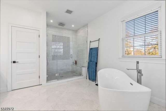 full bath with visible vents, marble finish floor, a stall shower, baseboards, and a soaking tub