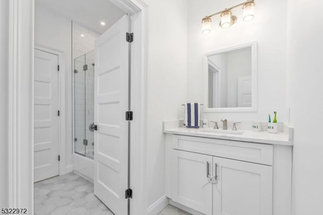 bathroom with vanity and shower / bath combination with glass door