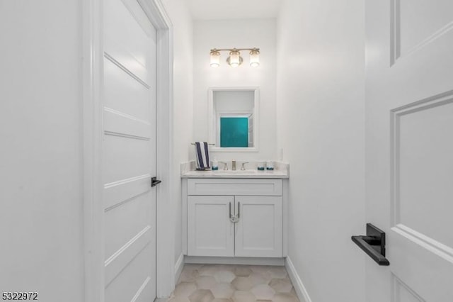 bathroom with baseboards and vanity