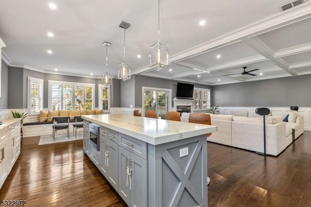 kitchen featuring a wainscoted wall, visible vents, coffered ceiling, ceiling fan, and gray cabinetry