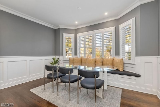 living area featuring plenty of natural light, ornamental molding, and wood finished floors