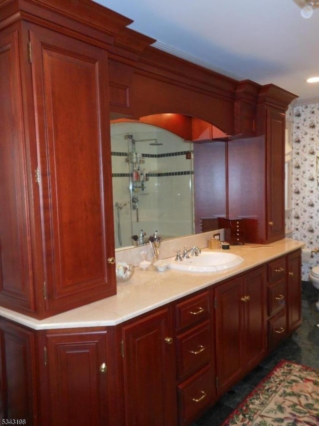 full bath featuring vanity, toilet, and a shower with shower door