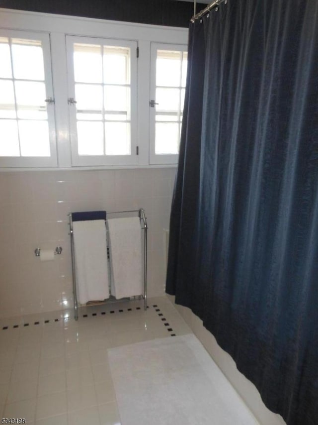 interior space featuring tile patterned floors and radiator