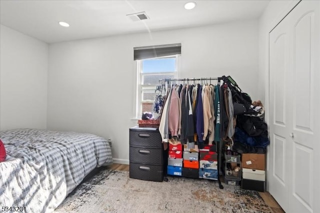 bedroom featuring wood finished floors, recessed lighting, and visible vents