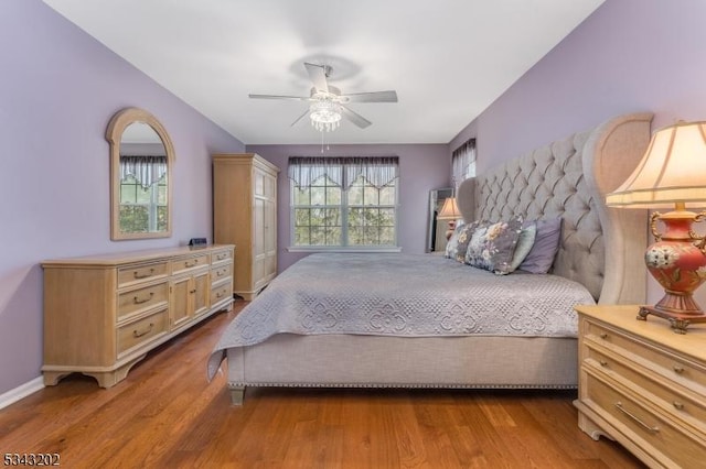 bedroom with ceiling fan and wood finished floors