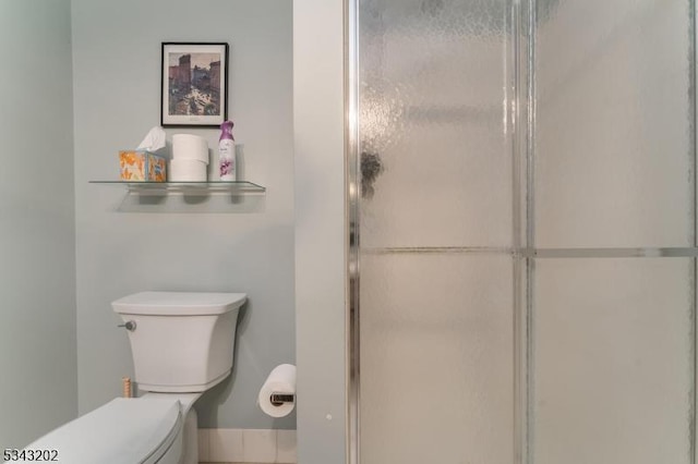 full bathroom with toilet and a stall shower