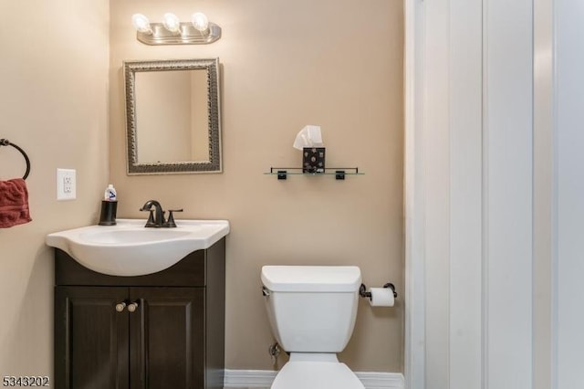 half bathroom with toilet and vanity