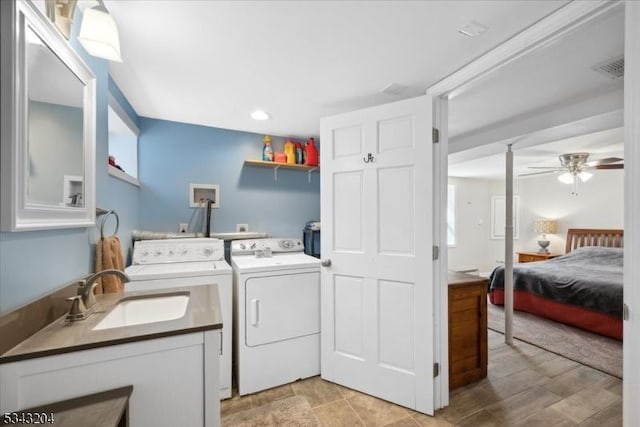 laundry room featuring visible vents, laundry area, ceiling fan, a sink, and independent washer and dryer