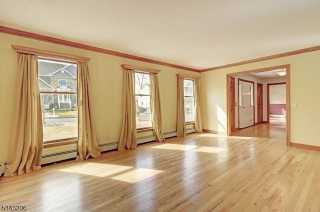 unfurnished room with light wood-style flooring, baseboards, and ornamental molding