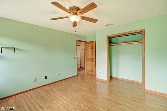 unfurnished bedroom featuring a closet, visible vents, light wood-type flooring, and baseboards