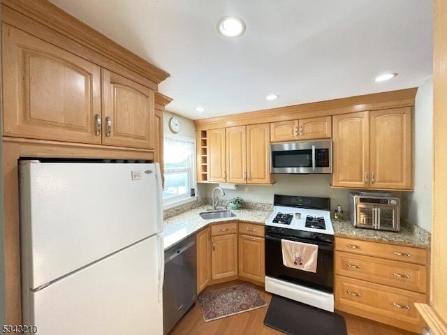 kitchen with open shelves, recessed lighting, a sink, stainless steel appliances, and light wood-style floors