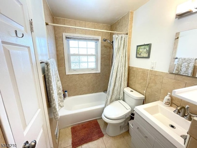 bathroom featuring tile walls, toilet, shower / tub combo with curtain, tile patterned floors, and vanity