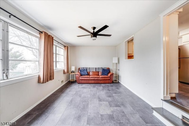 unfurnished room featuring baseboards and a ceiling fan