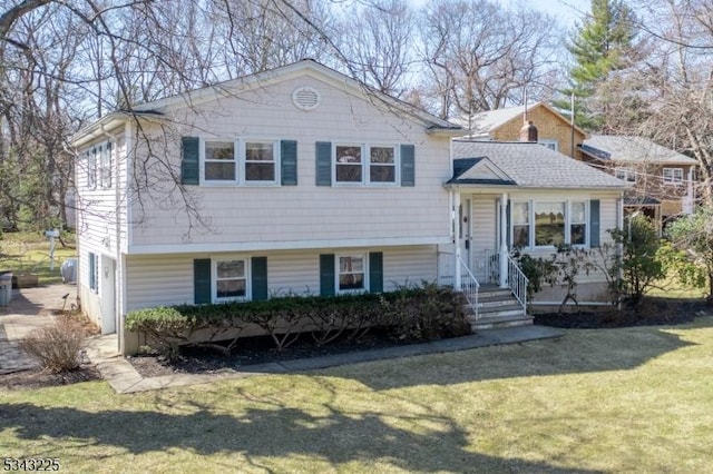 tri-level home with a front lawn