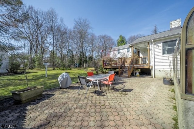 view of patio / terrace featuring a deck and outdoor dining space