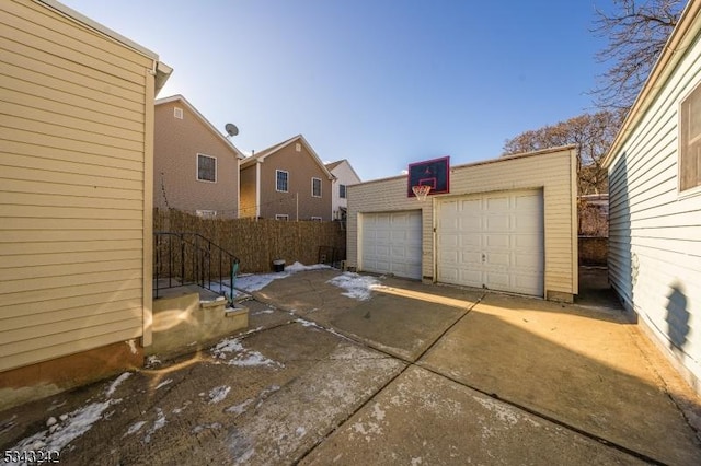 detached garage featuring fence