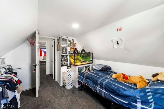 bedroom featuring lofted ceiling and dark colored carpet